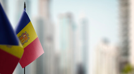 A small Andorra flag on an abstract blurry background - obrazy, fototapety, plakaty