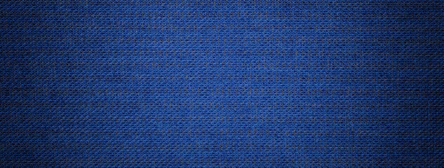 Navy blue background from textile material with wicker pattern, and vignette. Structure of denim...
