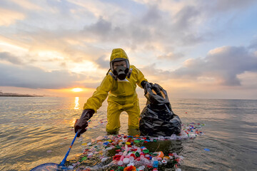 Slow violence. Volunteer biologist cleans up the ocean sea from plastic and corks wearing a suit and gas mask due to polluted waters. People protect the environment
