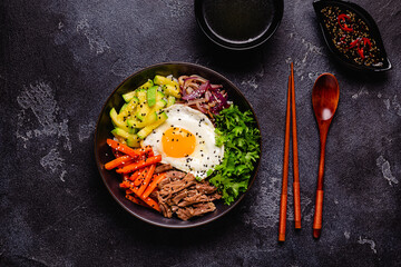 Traditional Korean dish Bibimbap: rice with vegetables beef and egg.