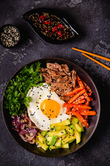Traditional Korean dish Bibimbap: rice with vegetables beef and egg.