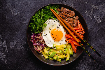 Traditional Korean dish Bibimbap: rice with vegetables beef and egg. - obrazy, fototapety, plakaty