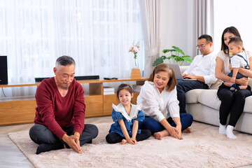 Fototapeta premium The family have fun relax engaged in fitness yoga at home using online instruction from laptop