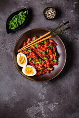 Tteokbokki, Teopokki fried rice cake in black bowl.