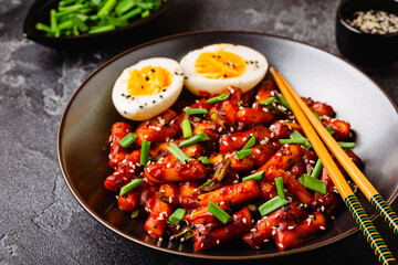 Tteokbokki, Teopokki fried rice cake in black bowl.