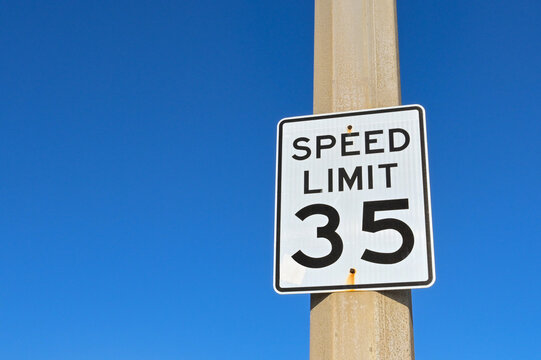 Speed limit sign in the USA isolated against a deep blue sky. No people. Copy space,