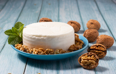Close-up of a piece of fresh goat cheese and walnuts.