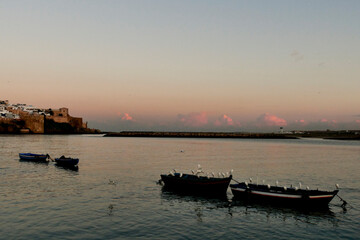 Obraz premium Sunrise over the Bouregreg River overlooking the modern buildings of Rabat, among which the futuristic Mohammed VI tower stands out