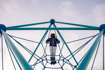 Girl standing tall on play structure