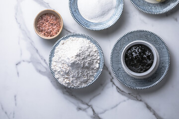 Ingredients for baking buns: wheat flour, yogurt, vegetable oil, salt, baking powder on a marble background, top view. Cooking delicious homemade food