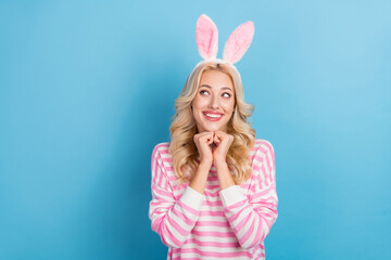Photo of excited woman wear striped sweater bunny headband arms hands chin looking empty space...