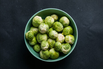 Raw Organic Brussel Sprouts in a Bowl, top view. Flat lay, overhead, from above. Copy space.