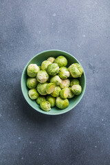 Raw Organic Brussel Sprouts in a Bowl, top view. Flat lay, overhead, from above. Copy space.