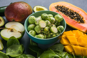 Healthy food clean food selection: fruits, vegetables, superfoods,  leaf vegetable on a gray concrete background
