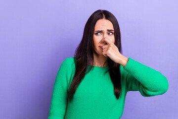 Young woman photo closing her nose look side hear unpleasant smell stink stinky smelly spoiled food isolated violet color background - obrazy, fototapety, plakaty