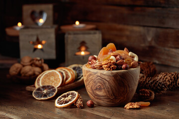 Dried fruits and assorted nuts on a wooden table.