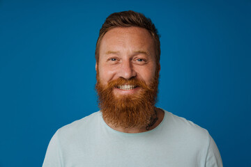 Obraz premium Portrait of adult bearded tattooed handsome stylish smiling man