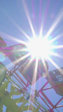 Amusement Park Ride with Direct Sun Vertical video