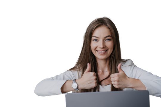 Beautiful blonde girl sitting at laptop, looking at the camera, showing thumbs up with both hands against transparent background. Cheerful European student has finished her studies. - Powered by Adobe