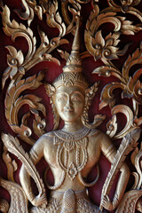 Deva sculpted on a door of Wat Dab Phai, Chiang Mai. Thailand.