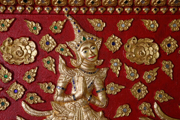 Deva sculpted on a wall of Wat Suandok pagoda, Chiang Mai. Thailand.