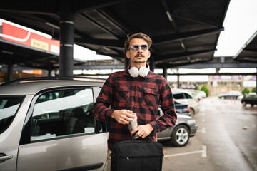 Fototapeta na wymiar one man happy caucasian male standing at the parking lot in day