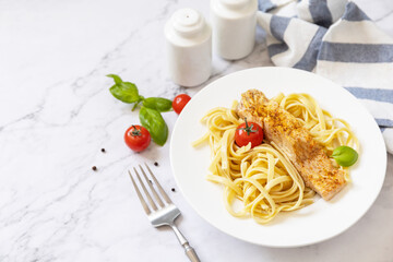 Gluten-free spaghetti pasta with grilled salmon in cream cheese on a marble background. Copy space.