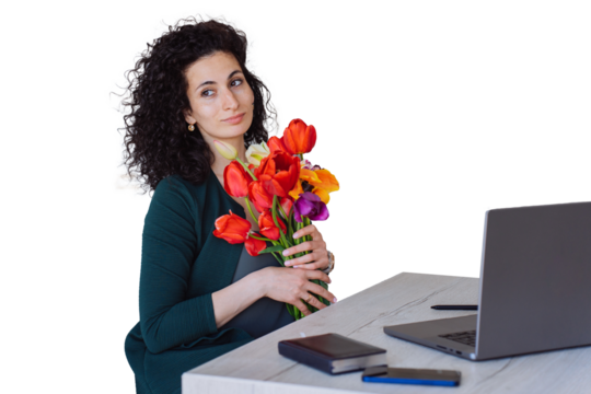 Confident grateful curly Spanish young woman sitting at table with laptop holds colourful tulips . Remote working hispanic businesswoman got flowers on women day, mother's day. transparent background