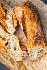fresh baguette white long bread whole wheat flour, wheat bread, sourdough healthy meal food snack on the table copy space food background rustic top view