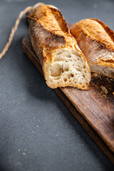 fresh baguette white long bread whole wheat flour, wheat bread, sourdough healthy meal food snack on the table copy space food background rustic top view