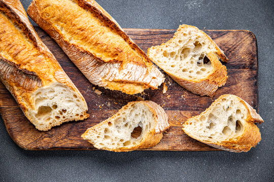 fresh baguette white long bread whole wheat flour, wheat bread, sourdough healthy meal food snack on the table copy space food background rustic top view