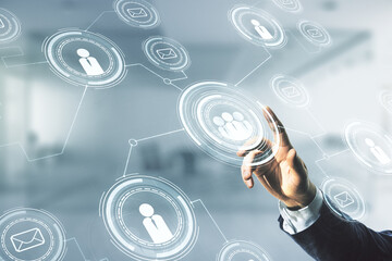 Double exposure of man hand presses on abstract virtual social network icons on blurred office background. Marketing and promotion concept