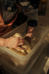 Woman's hands kneading dough