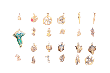 Metal pendants, close-up, isolated on a white background. Vintage amulets of gold with runes and in the form of animals on a black background.