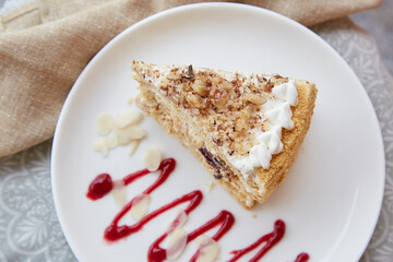 Honeydew cake with prunes and nuts on the plate top view. Sugar free, gluten free, vegan piece of cake