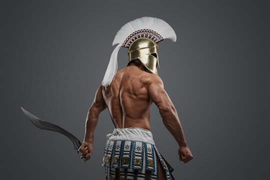 Shot of isolated on gray background muscular warrior from antique greece.