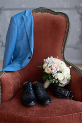 jacket, shoes, belt, a bouquet on a chair. Groom's morning, wedding details