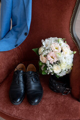 jacket, shoes, belt, a bouquet on a chair. Groom's morning, wedding details