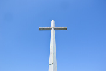 A large cross against a clear blue sky