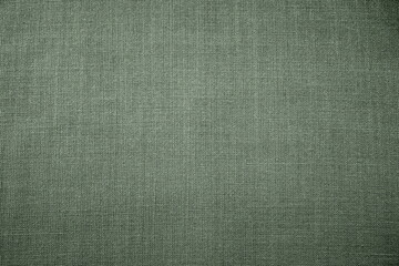 green background fabric texture. A piece of woolen cloth is neatly laid out on the surface. Weave and textile texture. Dress fabric or for kitchen needs, tablecloth or curtains, close-up. Dash