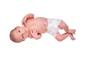 A happy newborn baby is smiling on a white changing table with a ruler for measuring height, isolated on a white background