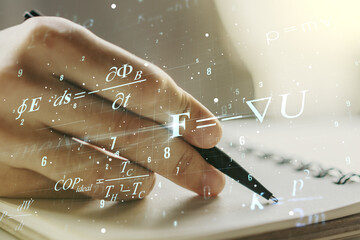 Creative scientific formula illustration with man hand writing in diary on background, science and...