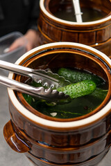 Cucumber pickles in a wooden barrel in the food market