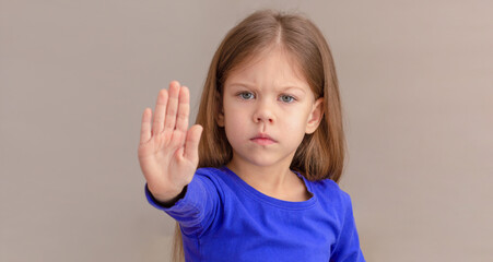 Child showing hand as sign to stop focus on kid