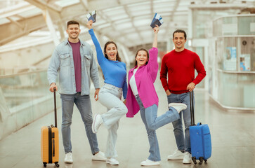 Fototapeta na wymiar Friends Going Holding Tickets Standing With Travel Suitcases In Airport
