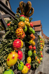 Traditionally decorated easter fountain seen in Bavaria (Germany). Easter fountain. Osterbrunnen. Traditional german easter eggs outdoor decoration. Rothenburg ob der Tauber, Bavaria - 580789268