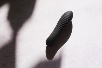 Black vibrator top view. Sex toy concept