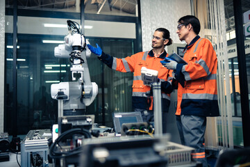 Multiracial tachnicial engineer training with robot arm