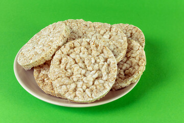Wheat crumbs on a plate on a white background