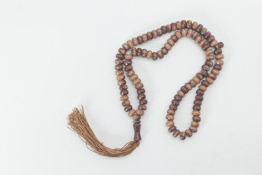 wood beads for keeping count of muslim prayers, Islamic muslim prayer beads on white background